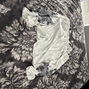 White House Black Market Ivory Top with blue floral embroidery on the sleeves